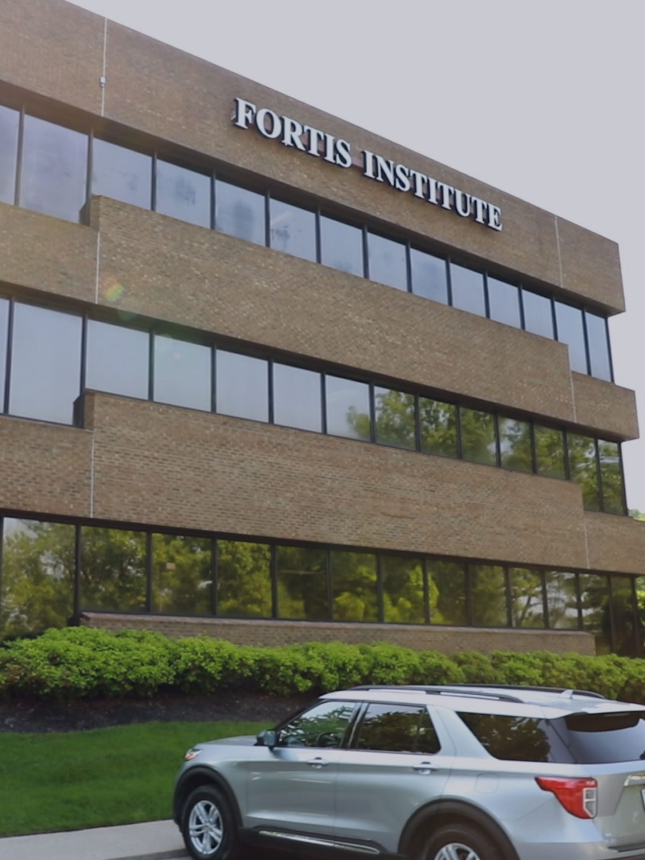 Fortis Institute building with parked SUV